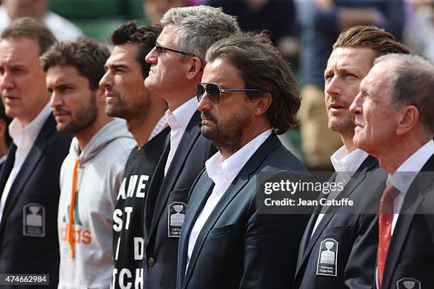 Henri Leconte and other members of the French Davis Cup Players' Club attend the tribute on Center Court honoring the late French tennis champion...