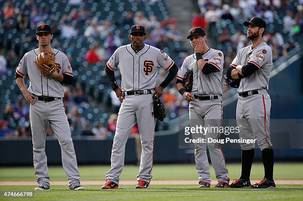 Infielders Matt Duffy, Joaquin Arias of the San Francisco Giants, Joe Panik and Brandon Belt of the San Francisco Giants look on a relief pitcher...
