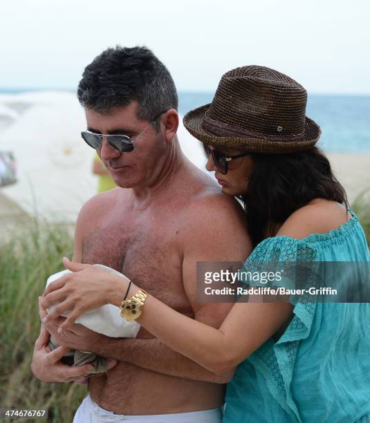 Simon Cowell and Lauren Silverman are seen with their newborn son, Eric Cowell, while at the beach on February 24, 2014 in Miami, Florida.