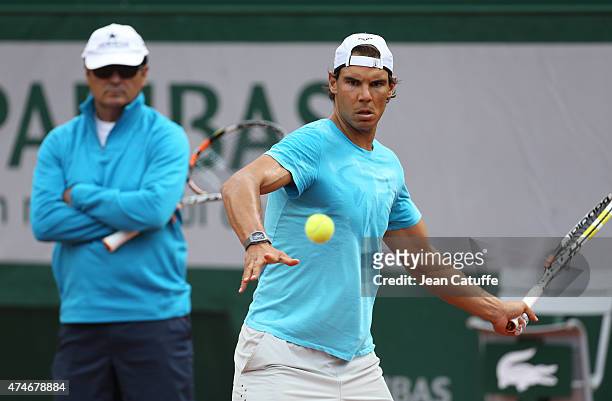 Rafael Nadal of Spain is practicing while his coach/uncle Toni Nadal looks on prior to the French Open 2015 at Roland Garros stadium on May 22, 2015...