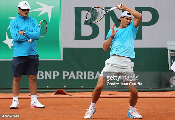 Rafael Nadal of Spain is practicing while his coach/uncle Toni Nadal looks on prior to the French Open 2015 at Roland Garros stadium on May 22, 2015...