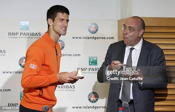 Novak Djokovic of Serbia celebrates his 28th birthday by eating a cake offered by the tournament and its director Gilbert Ysern prior to the French...