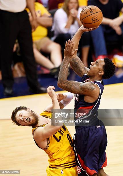Jeff Teague of the Atlanta Hawks shoots against Matthew Dellavedova of the Cleveland Cavaliers in the fourth quarter during Game Three of the Eastern...