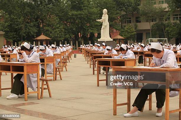 Students from College of Nursing in a vocational school take part in graduation examination outside classroom on May 25, 2015 in Baoji, Shaanxi...