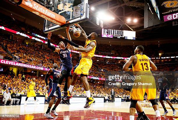 LeBron James of the Cleveland Cavaliers dunks against Mike Muscala and Kent Bazemore of the Atlanta Hawks in the third quarter during Game Three of...