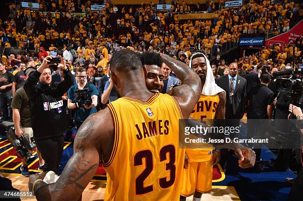 LeBron James and Iman Shumpert of the Cleveland Cavaliers shares a moment after the game against the Atlanta Hawks at the Quicken Loans Arena During...