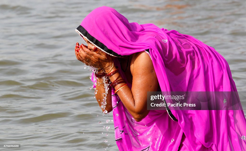 A woman  enjoying  the beach to beat the rising temperature...