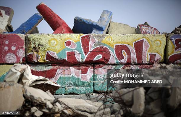 Picture taken on May 25, 2015 at the sea port in Gaza City, shows a graffiti reading in Arabic "I love my homeland" that was painted on a wall by a...