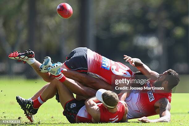 Lance Franklin is tackled by teammates George Hewett and Ryan O'Keefe during a Sydney Swans AFL training session at Lakeside Oval on February 25,...