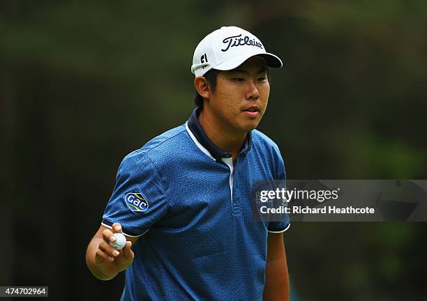 Byeong-Hun An of South Korea acknowledges the crowd on the 13th green during day 4 of the BMW PGA Championship at Wentworth on May 24, 2015 in...