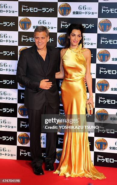 Movie star George Clooney and his wife Amal smile for photo call at the Japan premiere of his latest movie "Tomorrowland" in Tokyo on May 25, 2015....