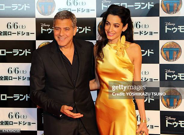 Movie star George Clooney and his wife Amal smile for photo call at the Japan premiere of his latest movie "Tomorrowland" in Tokyo on May 25, 2015....