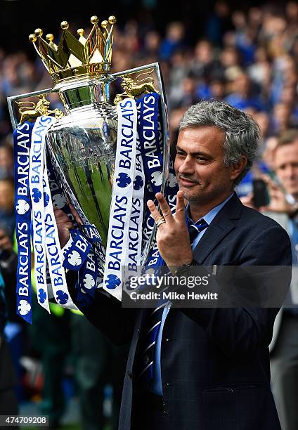 Jose Mourinho manager of Chelsea holds up three fingers as he celebrates with the trophy after the Barclays Premier League match between Chelsea and...
