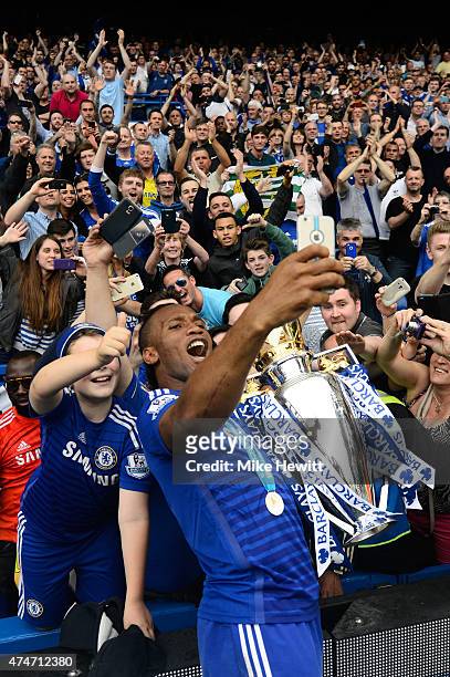Didier Drogba of Chelsea celebrates with fans and the trophy after the Barclays Premier League match between Chelsea and Sunderland at Stamford...