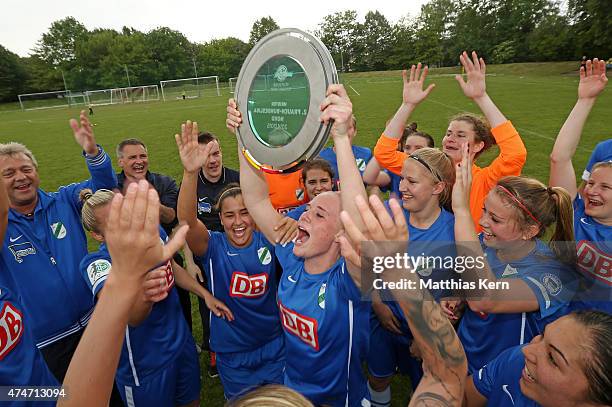 The team of Luebars celebrate with the trophy after winning the Women's Second Bundesliga match between FFV Leipzig and 1.FC Luebars at Sportschule...