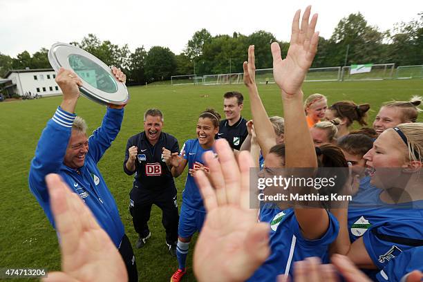 Head coach Juergen Franz of Luebars and his team celebrate with the trophy after winning the Women's Second Bundesliga match between FFV Leipzig and...