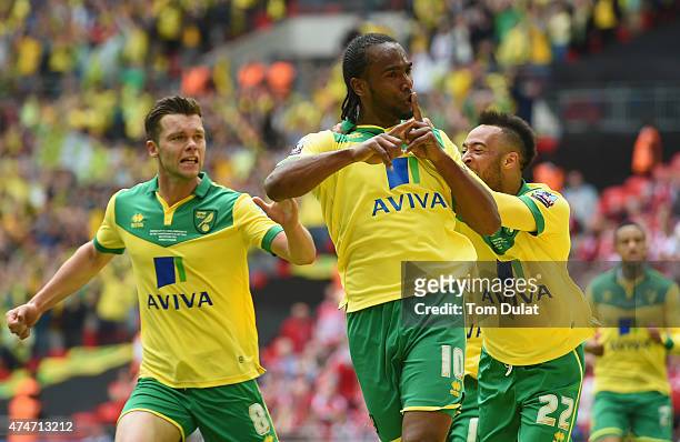 Cameron Jerome of Norwich City celebrates as he scores their first goal with Jonathan Howson and Nathan Redmond during the Sky Bet Championship...