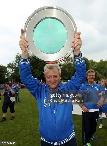 Head coach Juergen Franz of Luebars poses with the trophy after winning the Women's Second Bundesliga match between FFV Leipzig and 1.FC Luebars at...