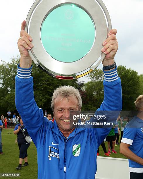 Head coach Juergen Franz of Luebars poses with the trophy after winning the Women's Second Bundesliga match between FFV Leipzig and 1.FC Luebars at...