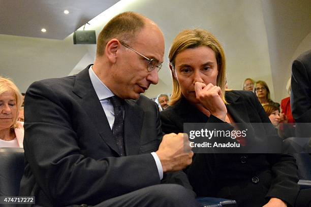 European Union Foreign Policy chief Federica Mogherini speaks with former Italian Prime Minister Enrico Letta as Mogherini receives the 2015 prize of...