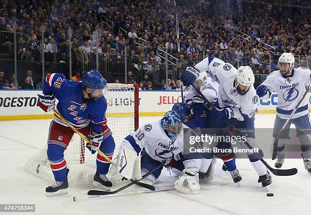 Ben Bishop and Jason Garrison of the Tampa Bay Lightning defend against Martin St. Louis of the New York Rangers in Game Five of the Eastern...