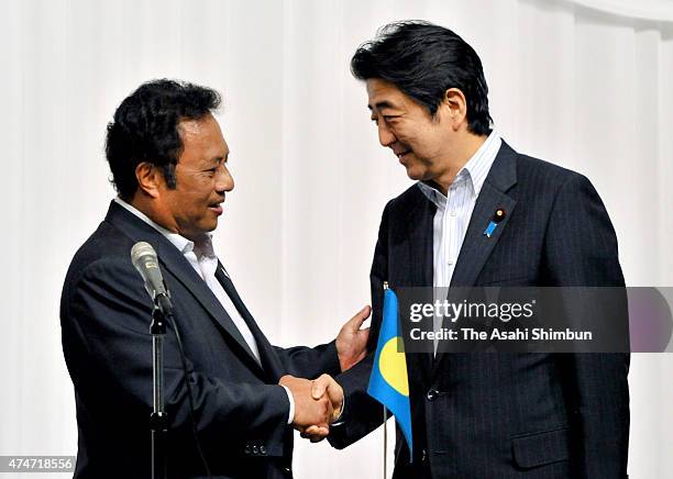 Japanese Prime Minister Shinzo Abe and co-chair and Palau President Tommy Remengesau shake hands after a joing press conference during the Pacific...