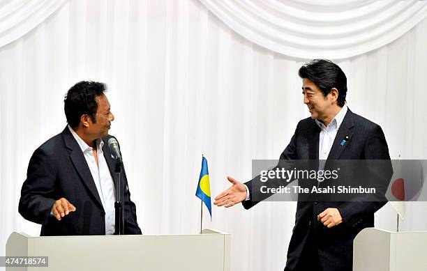 Japanese Prime Minister Shinzo Abe and co-chair and Palau President Tommy Remengesau shake hands after a joing press conference during the Pacific...