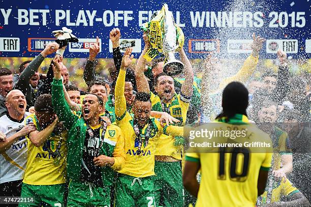 Cameron Jerome of Norwich City sprays his team mates with champagne in celebration after the Sky Bet Championship Playoff Final between Middlesbrough...