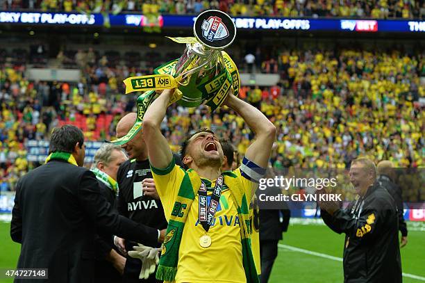 Norwich City's Scottish defender Russell Martin celebrates with the trophy after the official presentation after Norwich City won the English...