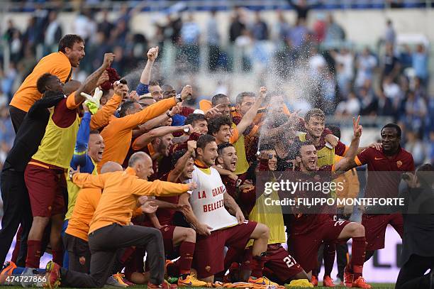 Roma's forward Francesco Totti wears a jersey reading "La Grande bellezza" as he celebrates with teammates after winning 1-2 the Italian Serie A...