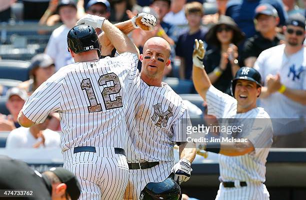Chase Headley of the New York Yankees celebrates his first inning two run home run against the Kansas City Royals with teammates Brett Gardner and...