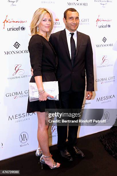 Actor Zinedine Soualem and his companion Caroline attend the Global Gift Gala : Photocall. Held at Four Seasons Hotel George V on May 25, 2015 in...