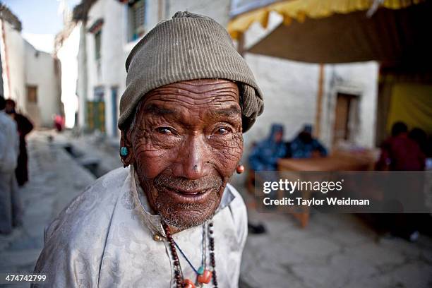 An elderly Loba man enters the main square of Lo Manthang during the Tiji Festival. Traditionally, Loba wear their finest clothes for important...