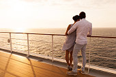 young couple hugging at sunset on cruise ship