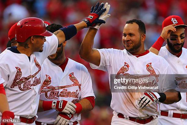 Jhonny Peralta of the St. Louis Cardinals is congratulated by teammates after hitting a walk-off solo home run against Arizona Diamondbacks in the...