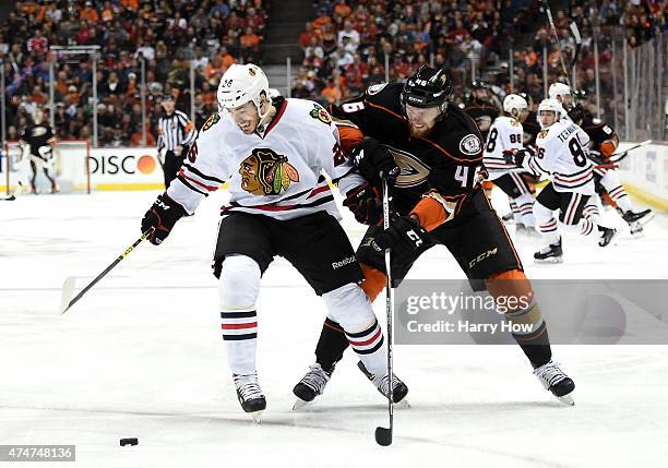 Kyle Cumiskey of the Chicago Blackhawks and Jiri Sekac of the Anaheim Ducks battle for the puck in the first period of Game Five of the Western...