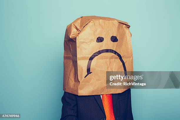 young boy businessman wears sad face - schaamte stockfoto's en -beelden