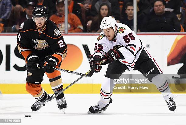 Andrew Shaw of the Chicago Blackhawks and Simon Despres of the Anaheim Ducks battle for the puck in the first period of Game Five of the Western...