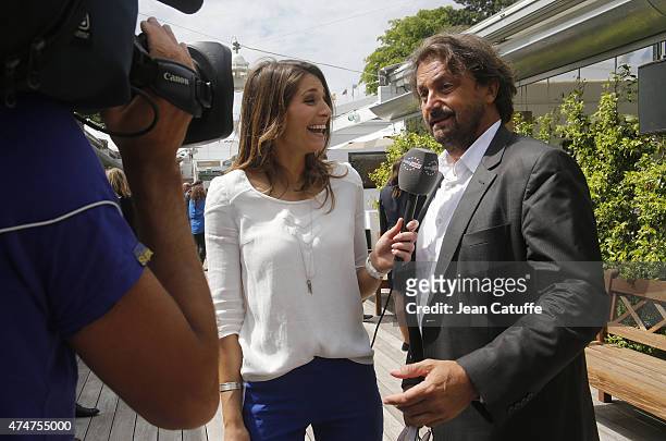 Henri Leconte is interviewed by Laury Thilleman for Eurosport during day 2 of the French Open 2015 at Roland Garros stadium on May 25, 2015 in Paris,...