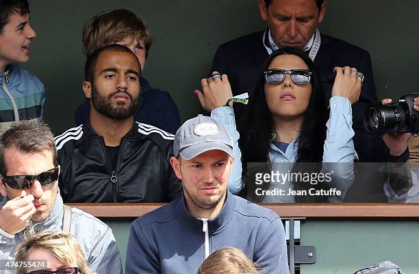Lucas Moura of PSG and his new girlfriend Larissa Saad attend day 2 of the French Open 2015 at Roland Garros stadium on May 25, 2015 in Paris, France.