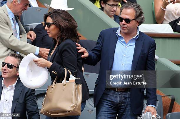 Luc Chatel and his girlfriend Mahnaz Hatami attends day 2 of the French Open 2015 at Roland Garros stadium on May 25, 2015 in Paris, France.