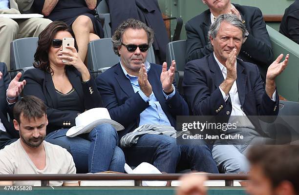 Luc Chatel sits between his girlfriend Mahnaz Hatami and Mayor of Deauville Philippe Augier during day 2 of the French Open 2015 at Roland Garros...