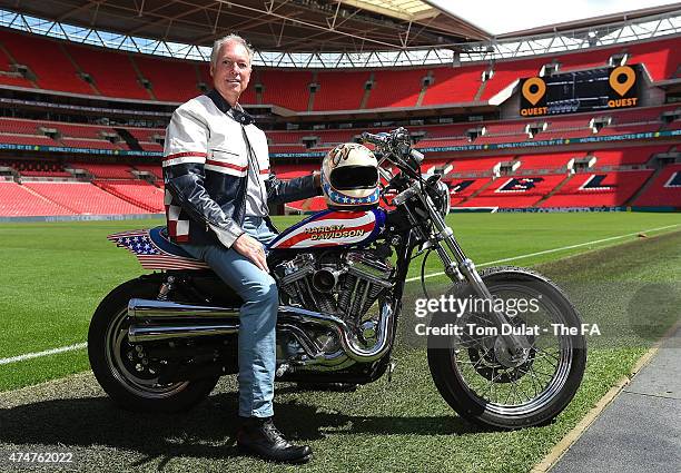 Kelly Knievel poses for photos prior to the Evel Knievel 40th Anniversary at Wembley Stadium with a replica of Evel Knievel's original motor bike and...