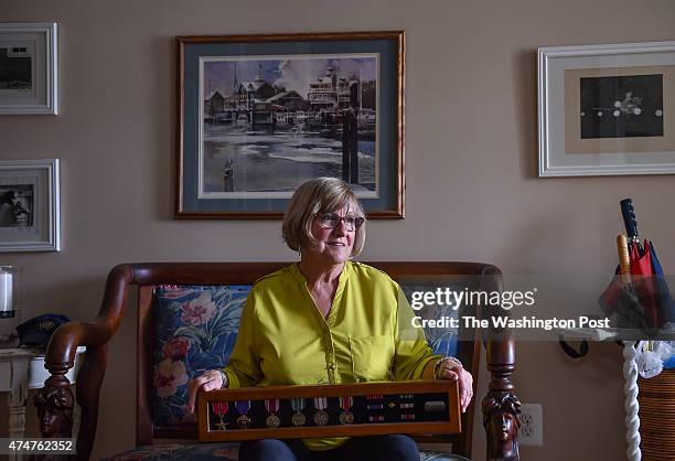 Billie Meeks is photographed in her home holding her father's WWII medals on May 11, 2015 in Lewes, De. Billie Meeks wasnt even born when her father...