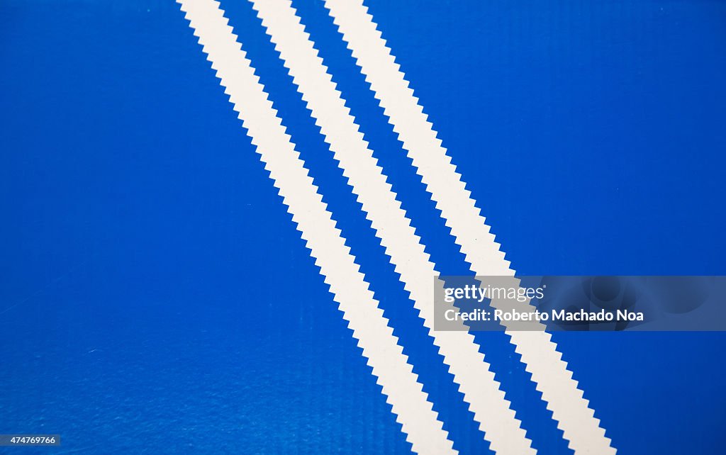 Old Adidas logo: Three white stripes on a blue background,...