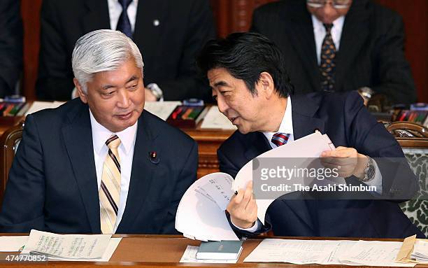 Japanese Prime Minister Shinzo Abe talks with Defense Minister gen Nakatani during a plenary session of the diet on May 26, 2015 in Tokyo, Japan....