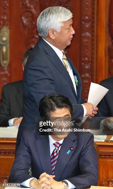 Japanese Defense Minister Gen Nakatani walks past Prime Minister Shinzo Abe to address during the lower house plenary session of the diet on May 26,...