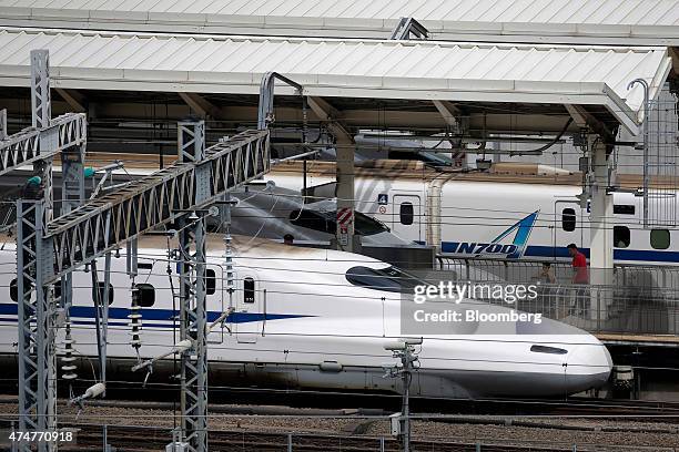 Central Japan Railway Co. N700 series Shinkansen bullet trains stand on the platform at Tokyo Station in Tokyo, Japan, on Sunday, May 24, 2015. Japan...