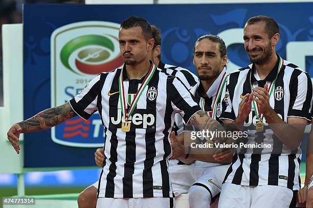 Simone Pepe of Juventus FC mocks his team mate Carlos Tevez at the end of the Serie A match between Juventus FC and SSC Napoli at Juventus Arena on...