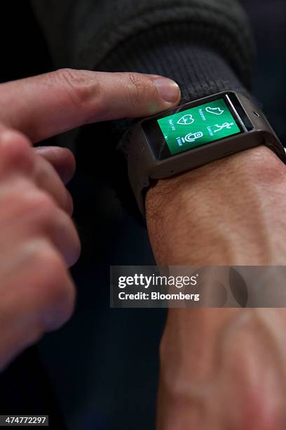 An attendee tests a Galaxy Gear 2 wearable device during a Samsung Electronics Co. News conference on the opening day of the Mobile World Congress in...